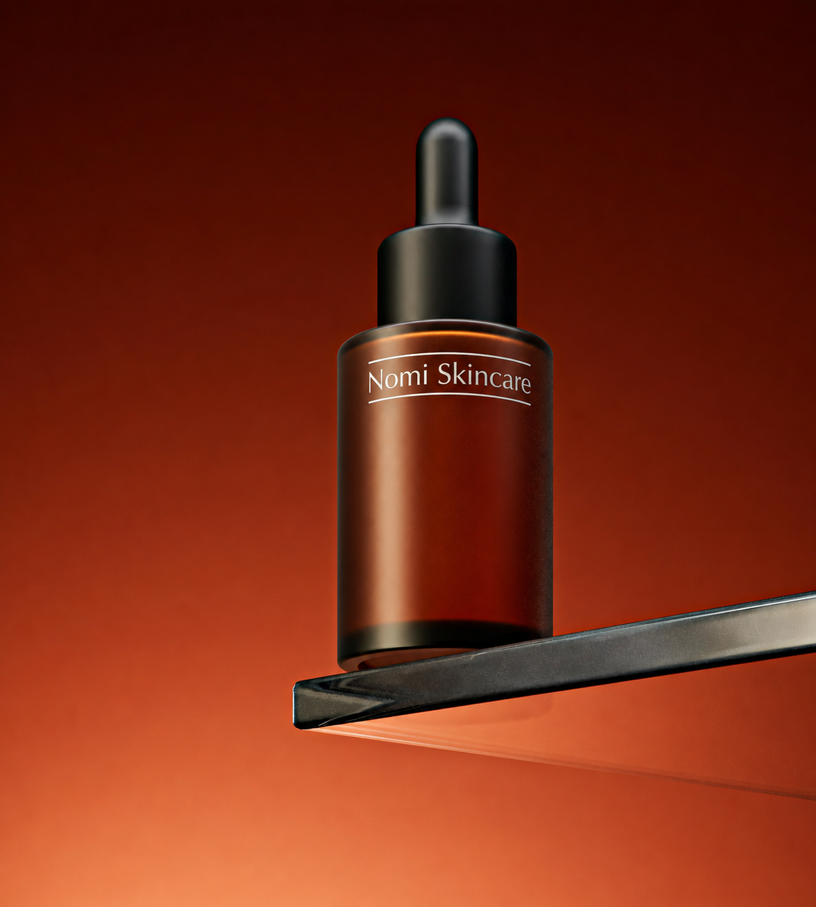 Nomi Skincare serum bottle lit against a dark ground
